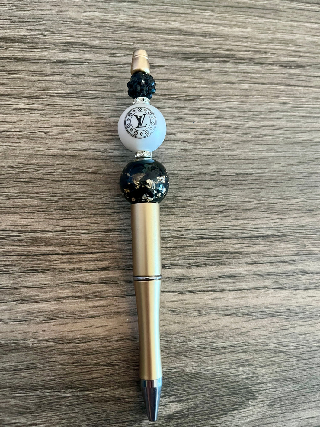 Gold pen with LV bead