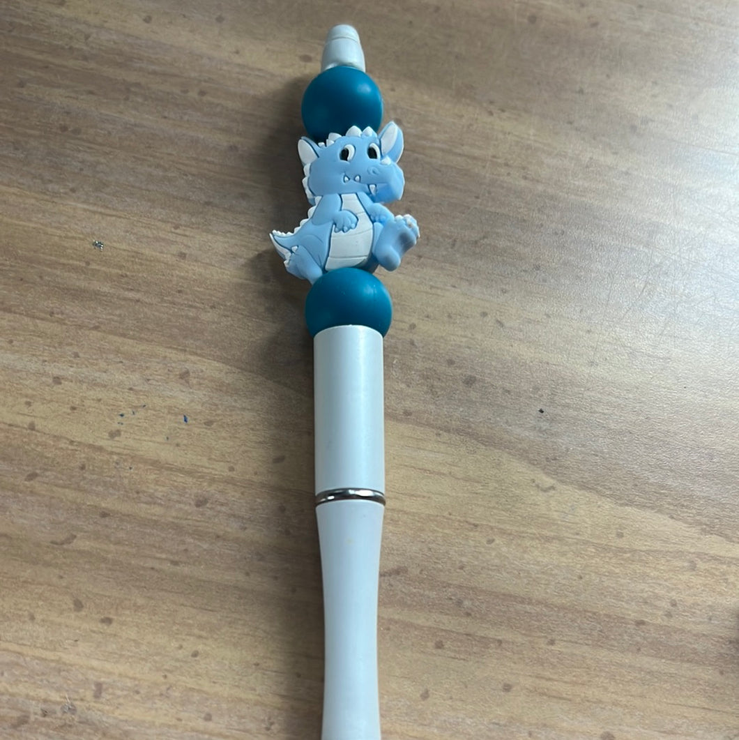White pen with blue dinosaur